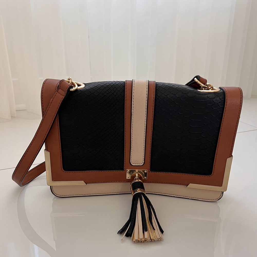 Woman’s black and beige tassle handbag